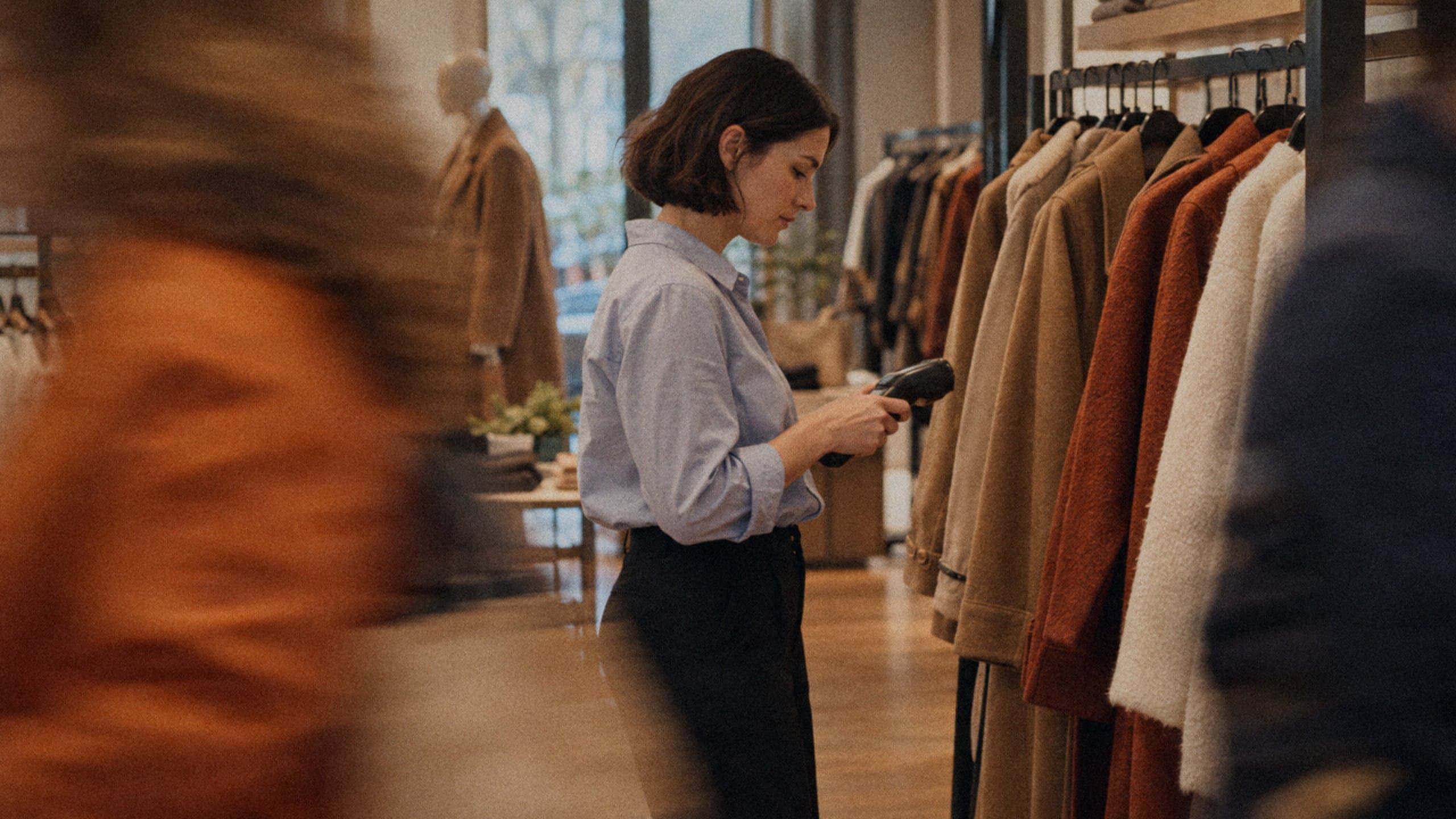 A store manager checking stock in a department store.